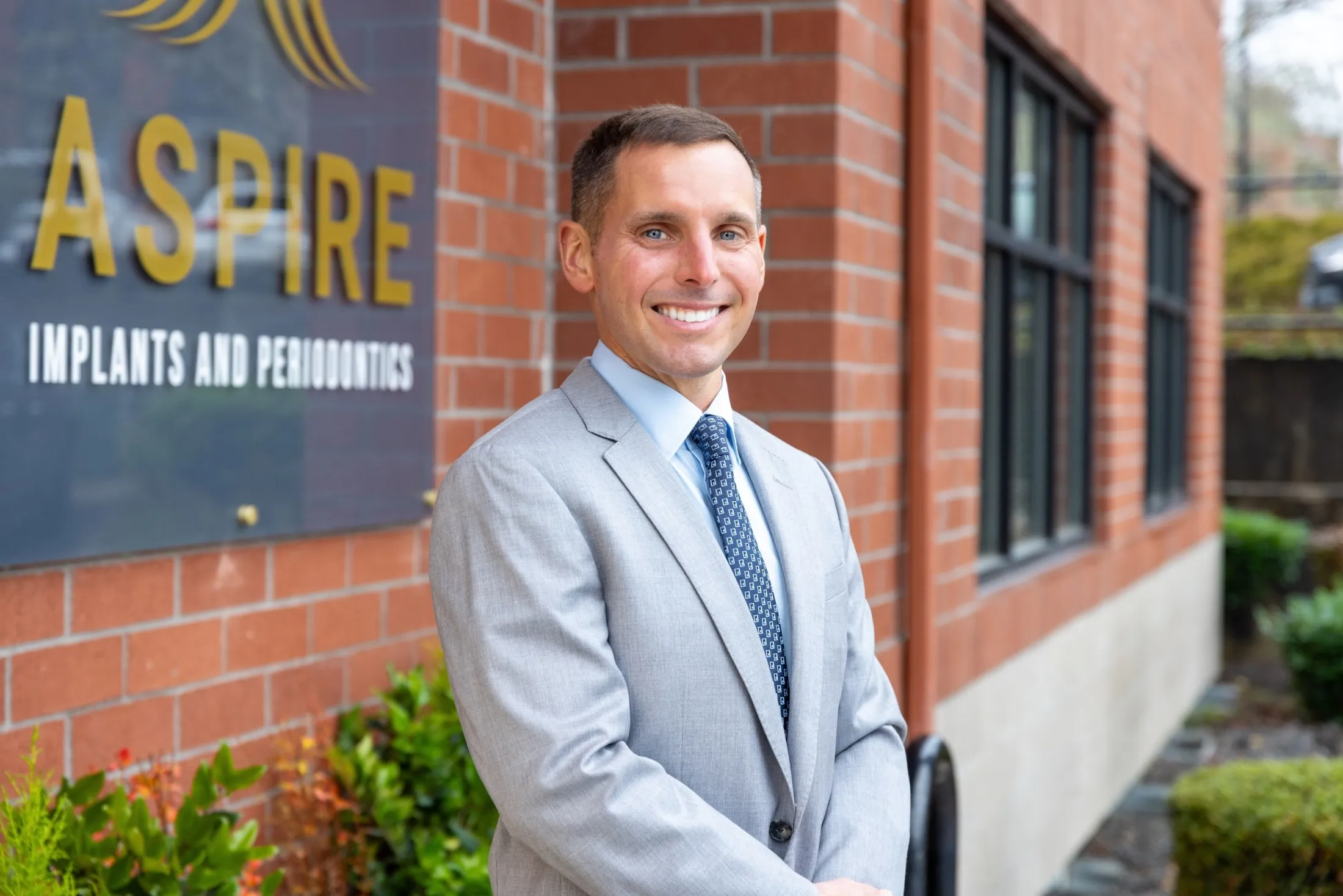 Dr. Mueller in front of office sign
